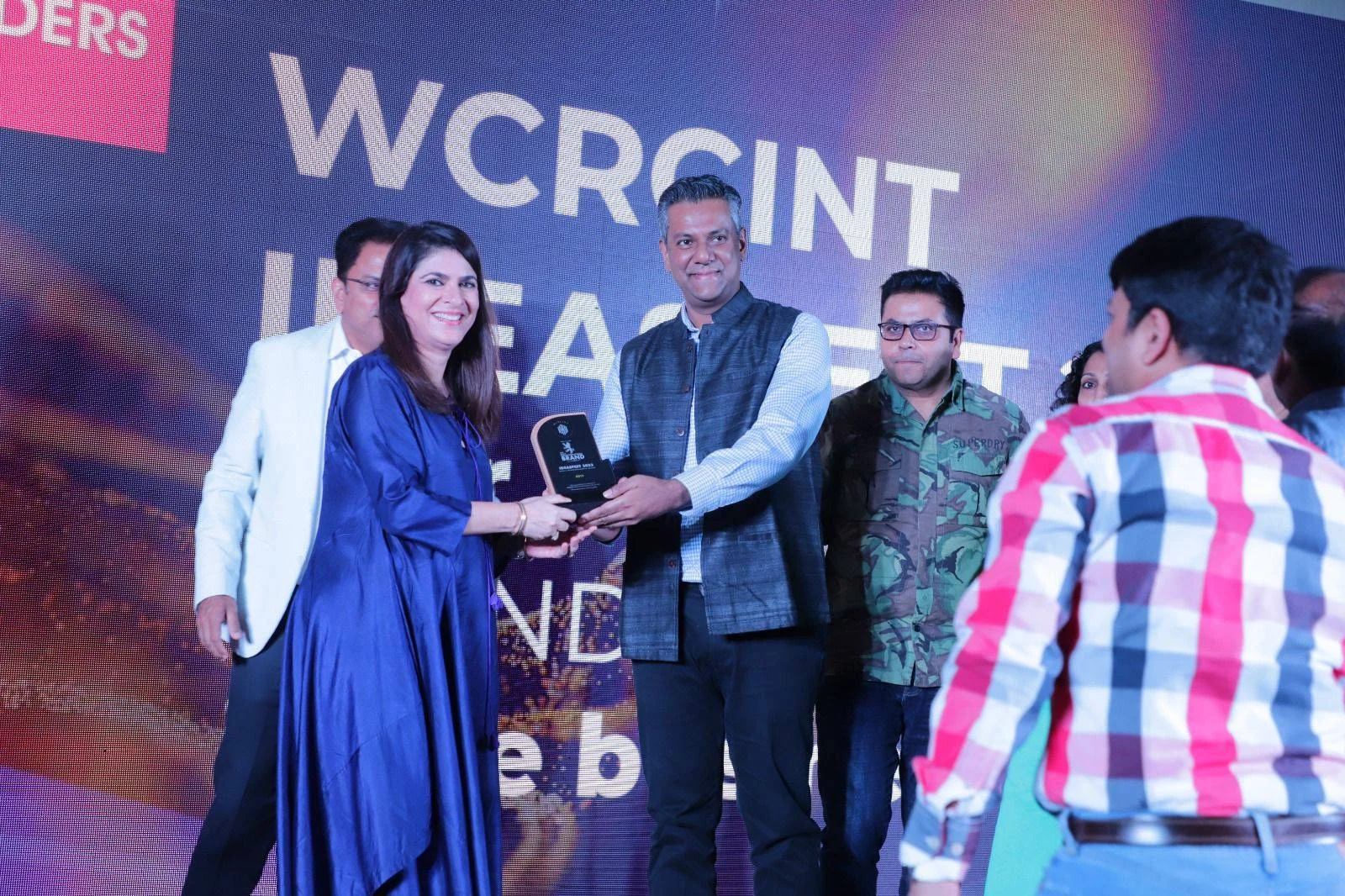 WCRC Leaders awards — the Brand of the Year trophy presented at WCRCINT IDEASFEST in front of the main stage screen